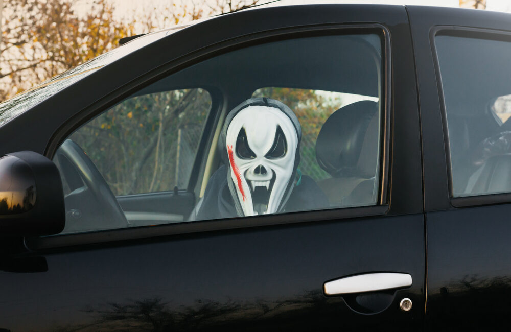 person driving with Halloween mask