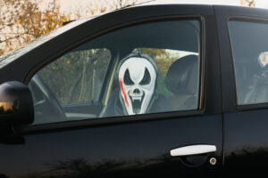 person driving with Halloween mask