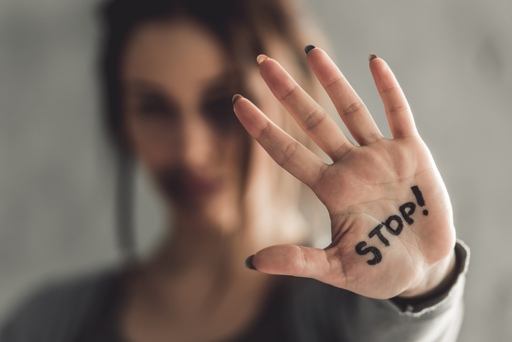 woman with hand that says stop