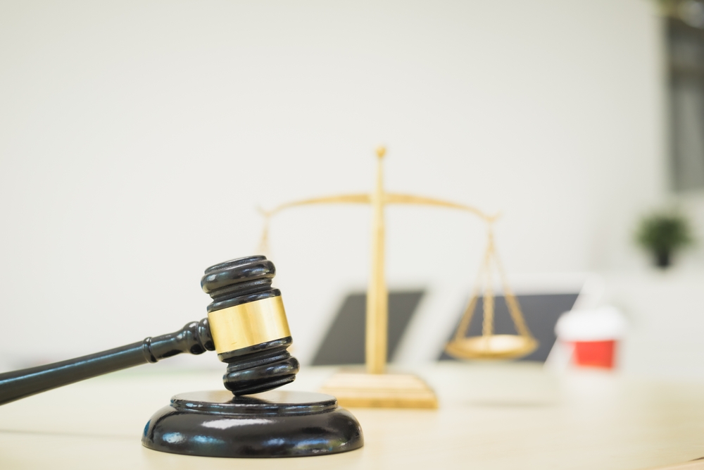 gavel on judge's bench along with scales