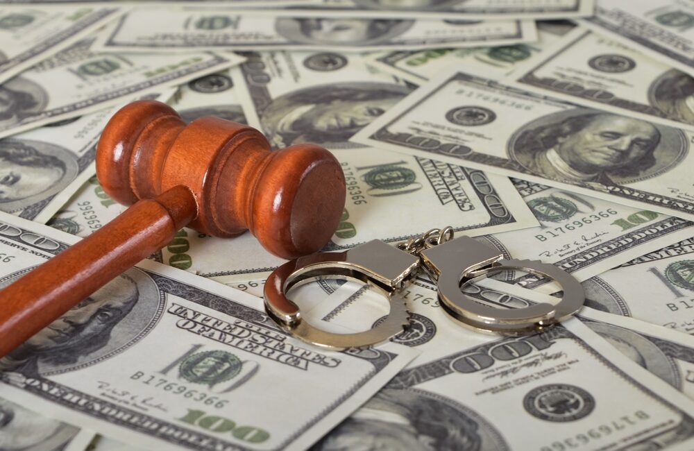 handcuffs, gavel and dollar bills