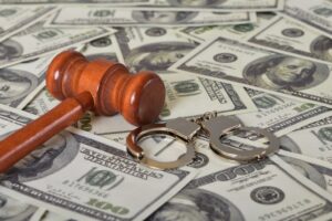 handcuffs, gavel and dollar bills